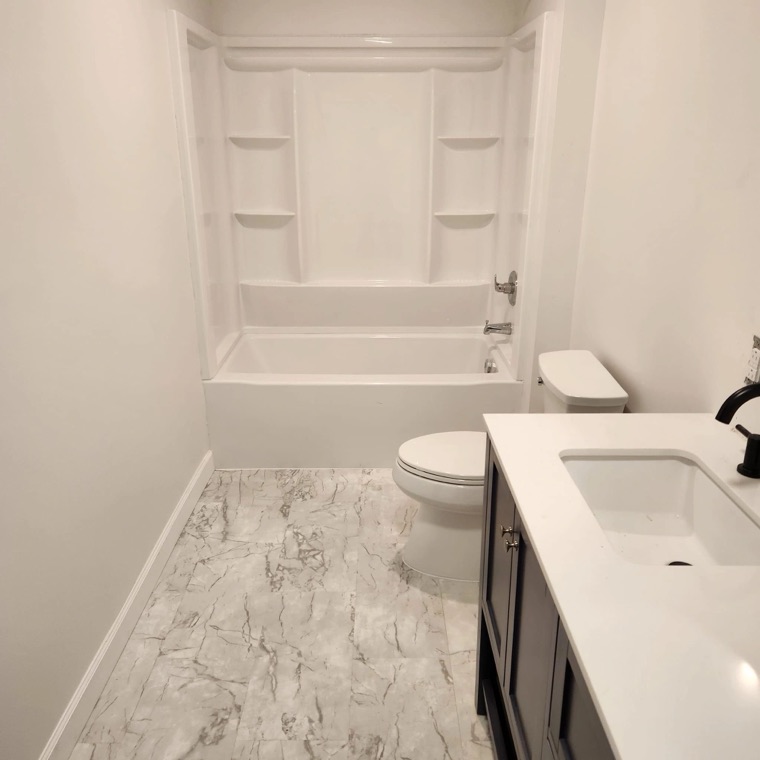 Bathroom with new tub, vanity and flooring