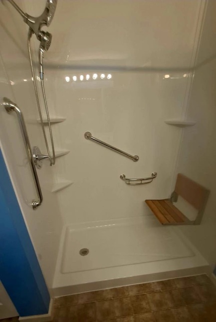 Safe shower with grab bars and a fold-down seat